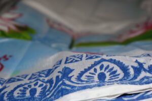 Close-up of Hand-Painted Muslin Saree with blue artisan motifs KhatiBaazaar